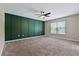 Spacious bedroom with decorative green wall and a ceiling fan at 7842 Carriage Pointe Dr, Gibsonton, FL 33534