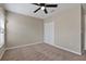 Neutral bedroom featuring a ceiling fan, carpet and closet with bi-fold doors at 7842 Carriage Pointe Dr, Gibsonton, FL 33534