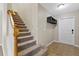 Inviting entryway with tile flooring, coat rack with hooks, and carpeted stairs at 7842 Carriage Pointe Dr, Gibsonton, FL 33534