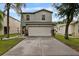 Charming two-story home featuring a well-maintained lawn, a two-car garage, and nice landscaping at 7842 Carriage Pointe Dr, Gibsonton, FL 33534