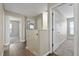 Upstairs hallway featuring wood floors and carpeted bedrooms at 7842 Carriage Pointe Dr, Gibsonton, FL 33534