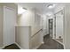 Upstairs hallway with wood floors leads to bedrooms and bathrooms at 7842 Carriage Pointe Dr, Gibsonton, FL 33534