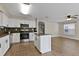 Bright kitchen with white cabinets, stainless steel appliances, and island at 7842 Carriage Pointe Dr, Gibsonton, FL 33534