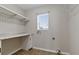 Functional laundry room with countertop, cabinet, and window at 7842 Carriage Pointe Dr, Gibsonton, FL 33534