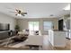 Stylishly furnished living room with wood-look flooring and a view of a modern kitchen at 7842 Carriage Pointe Dr, Gibsonton, FL 33534