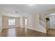 Bright living room with stylish wood floors, archways, and access to the staircase at 7842 Carriage Pointe Dr, Gibsonton, FL 33534
