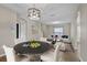 Staged living and dining area with neutral colors, wood floors, and modern furnishings at 7842 Carriage Pointe Dr, Gibsonton, FL 33534