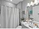 Cozy bathroom featuring a shower with gray tiling, bright lighting, and modern fixtures at 809 Seascape Pl, Sarasota, FL 34240