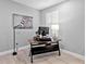 Bright home office with a standup desk, shuttered window, and sleek decor at 809 Seascape Pl, Sarasota, FL 34240