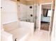 Spa-like bathroom featuring a separate glass shower and soaking tub at 8556 Tidal Bay Ln, Tampa, FL 33635