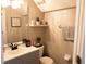 Stylish half bathroom featuring modern vanity, floating shelf and decorative accents at 8556 Tidal Bay Ln, Tampa, FL 33635