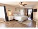 Bedroom features a king bed, ceiling fan, and workout area at 8556 Tidal Bay Ln, Tampa, FL 33635