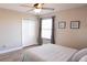 Cozy bedroom features a ceiling fan, neutral walls, and a double door closet at 8556 Tidal Bay Ln, Tampa, FL 33635