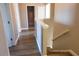 Upstairs hallway with wood-look floors leading to bedrooms and a full bathroom at 8556 Tidal Bay Ln, Tampa, FL 33635