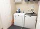 Functional laundry room with washer, dryer, shelving, and ample storage at 8556 Tidal Bay Ln, Tampa, FL 33635