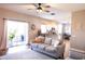 Spacious living room with sliding doors, a cozy sofa, and open access to kitchen and dining areas at 8556 Tidal Bay Ln, Tampa, FL 33635