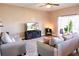 Comfortable living room featuring modern furniture, a large TV, and sliding glass doors to outdoor space at 8556 Tidal Bay Ln, Tampa, FL 33635