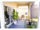 Relaxing screened patio with wooden rocking chairs and lots of plants at 8556 Tidal Bay Ln, Tampa, FL 33635