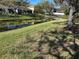 Scenic backyard view with lush lawn and pond, offering a tranquil and picturesque outdoor space at 8603 Egret Point Ct, Tampa, FL 33647