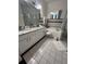 Bright bathroom featuring a large tub, granite countertop, decorative plants, and ample lighting at 8603 Egret Point Ct, Tampa, FL 33647
