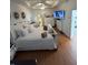 Bright bedroom features hardwood floors, ceiling fan, tv, and stylish furnishings at 8603 Egret Point Ct, Tampa, FL 33647