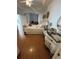 Bright bedroom features hardwood floors, ceiling fan, ornate decor, and stylish furnishings at 8603 Egret Point Ct, Tampa, FL 33647