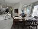 An inviting dining room features an elegant table, bright lighting, and seamless connection to the kitchen area at 8603 Egret Point Ct, Tampa, FL 33647