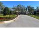 Community entrance gate showcasing landscaping and a secure entry, providing privacy and curb appeal at 8603 Egret Point Ct, Tampa, FL 33647