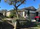 Charming home featuring a well-manicured lawn and an attached two-car garage at 8603 Egret Point Ct, Tampa, FL 33647