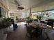 Relaxing screened patio with tile floor, ceiling fan, dining table, grill and comfortable seating with lots of natural light at 8603 Egret Point Ct, Tampa, FL 33647