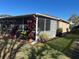Covered patio area with various potted plants and a screened enclosure at 8603 Egret Point Ct, Tampa, FL 33647