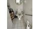 Small bathroom featuring an elevated toilet with handles for accessibility at 8603 Egret Point Ct, Tampa, FL 33647
