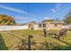 Spacious backyard with a white fence, lush lawn, and a cozy seating area, perfect for relaxing or entertaining guests at 8792 93Rd St, Seminole, FL 33777