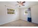 Bedroom featuring carpeted floor, ceiling fan, and natural light from two windows at 8792 93Rd St, Seminole, FL 33777