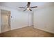 Bedroom with ceiling fan, neutral carpet, and light walls with view to kitchen at 8792 93Rd St, Seminole, FL 33777