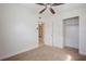 Bedroom with ceiling fan, neutral carpet, and light walls with closet access at 8792 93Rd St, Seminole, FL 33777