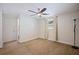 Bedroom with ceiling fan, neutral carpet, light walls, and large window with sheer curtains at 8792 93Rd St, Seminole, FL 33777
