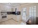 Efficient kitchen featuring white cabinets, tile backsplash, and a view to Florida Room at 8792 93Rd St, Seminole, FL 33777