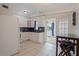 Modern kitchen featuring white appliances and tile flooring, with dining space nearby at 8792 93Rd St, Seminole, FL 33777