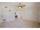 Open-concept living area with tile floors, a ceiling fan, and views into the kitchen at 8792 93Rd St, Seminole, FL 33777