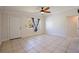 Inviting living room with neutral tile flooring, ample natural light, and a ceiling fan at 8792 93Rd St, Seminole, FL 33777