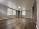 Spacious bedroom with windows, wood floors, neutral walls, and natural lighting at 8911 N Willow Ave, Tampa, FL 33604