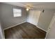 A cozy bedroom featuring wood floors, a ceiling fan, closet and a window at 8911 N Willow Ave, Tampa, FL 33604