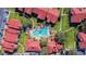 Aerial view of the community pool area with manicured lawns and mature trees at 9481 Highland Oak Dr # 404, Tampa, FL 33647