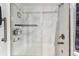 Updated bathroom with white marble-look shower, brushed nickel fixtures, and glass doors at 9481 Highland Oak Dr # 404, Tampa, FL 33647