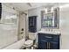 Bathroom featuring a shower over tub with glass enclosure and modern vanity at 9481 Highland Oak Dr # 404, Tampa, FL 33647