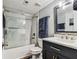 Bathroom featuring a shower over tub with glass enclosure and modern vanity at 9481 Highland Oak Dr # 404, Tampa, FL 33647