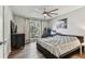 Well-lit bedroom with a large window, ceiling fan, and wood-look flooring at 9481 Highland Oak Dr # 404, Tampa, FL 33647