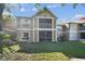 Two-story condo building with tan exterior, lawn and screened lanai on both floors at 9481 Highland Oak Dr # 404, Tampa, FL 33647