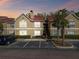 Apartment complex featuring reserved parking spaces, palm trees, and a well-maintained exterior, perfect for comfortable living at 9481 Highland Oak Dr # 404, Tampa, FL 33647